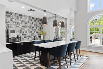 Community lounge with high top seating and pendant lighting